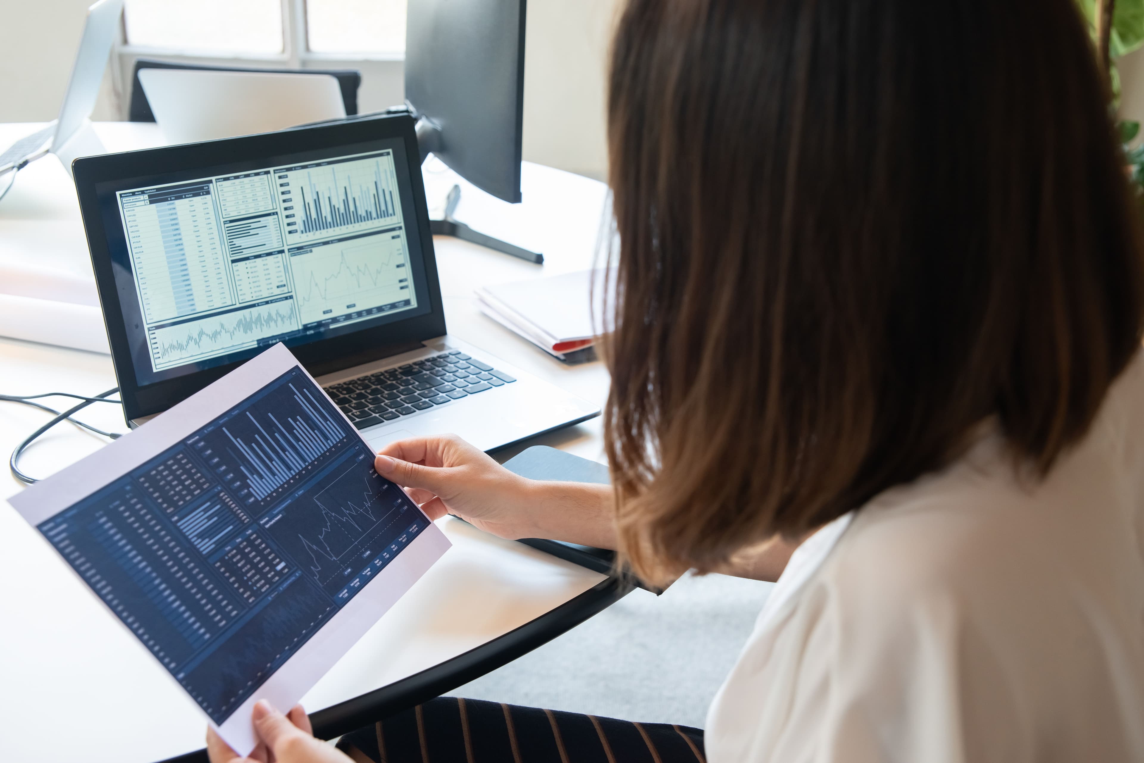 Financial analyst reviewing charts of AR data