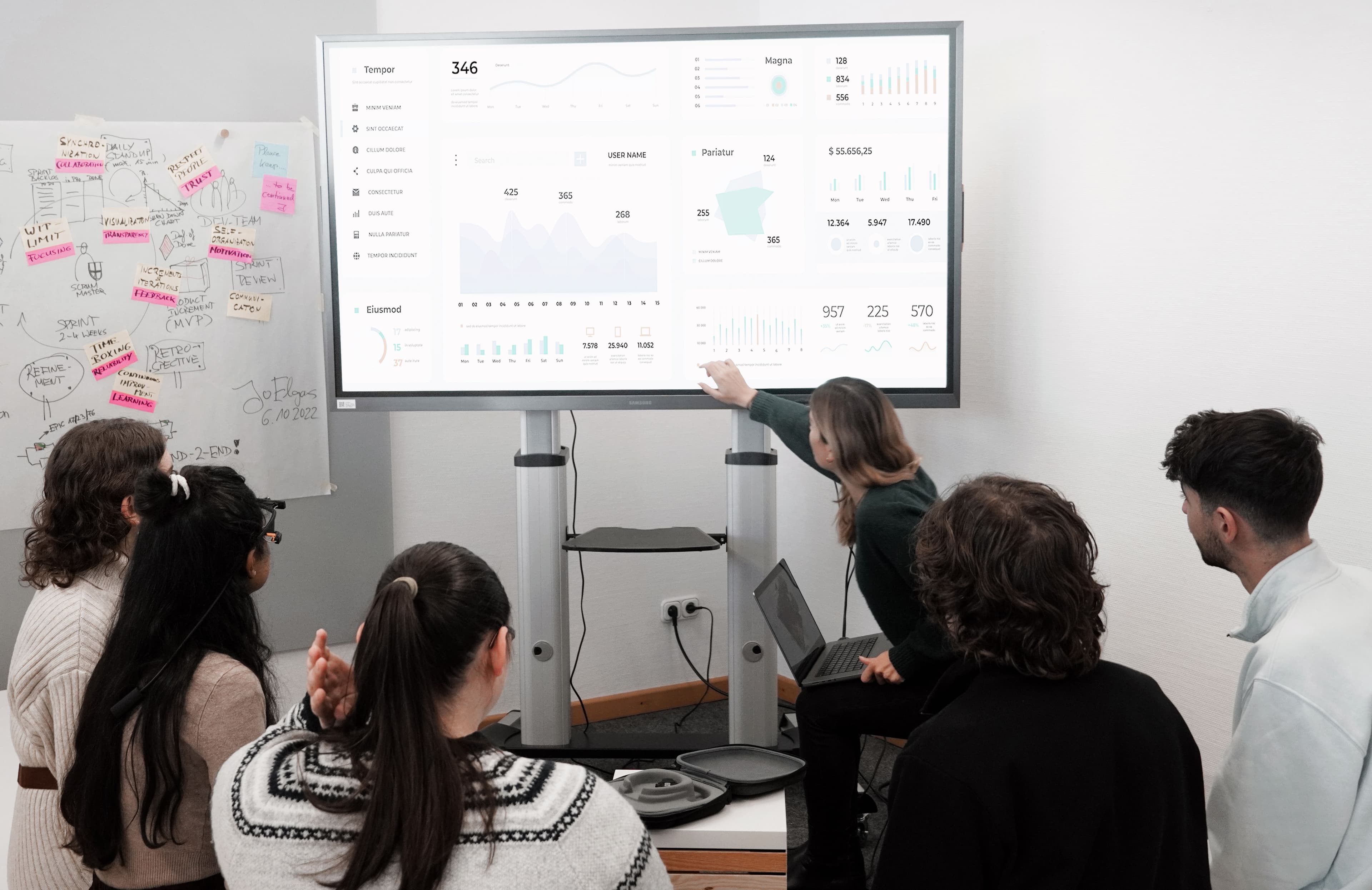 Care team reviewing patient data on a large digital dashboard