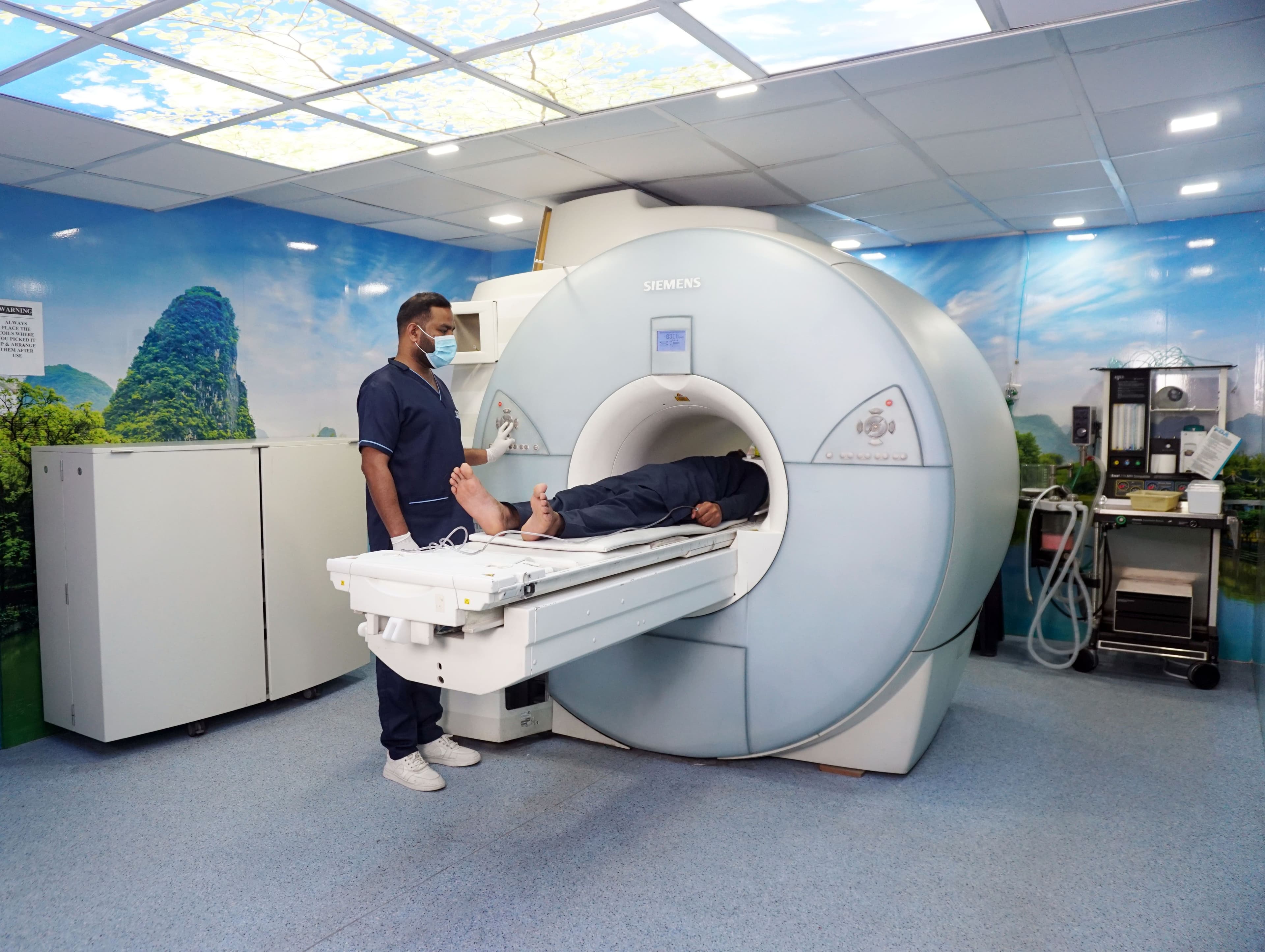 MRI technician operating the scanner